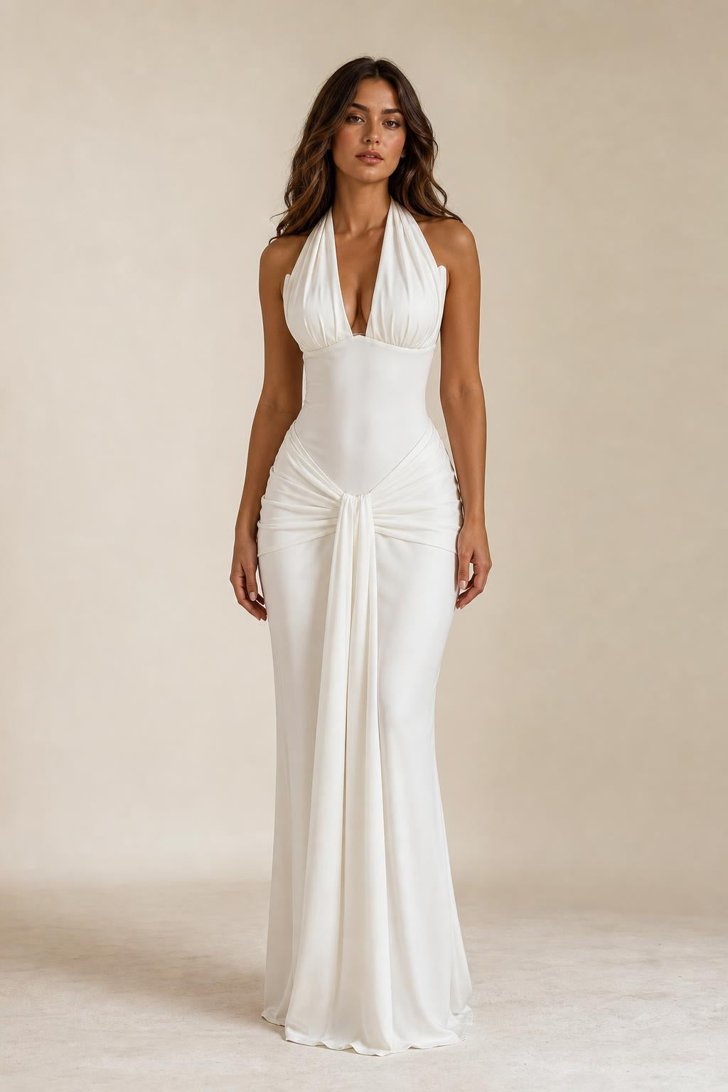 Front view of woman wearing white draped halter neck maxi dress