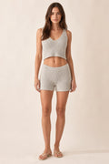 Front view of model wearing light grey ribbed knit crop tank and shorts set