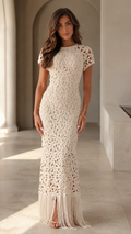 Front view of cream crochet-look fitted maxi dress with short sleeves and fringe hem