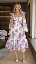 Front view of white floral tie-shoulder sweetheart midi dress with tiered skirt