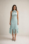 Front view of sage green satin halter neck midi dress with circle fringe hem