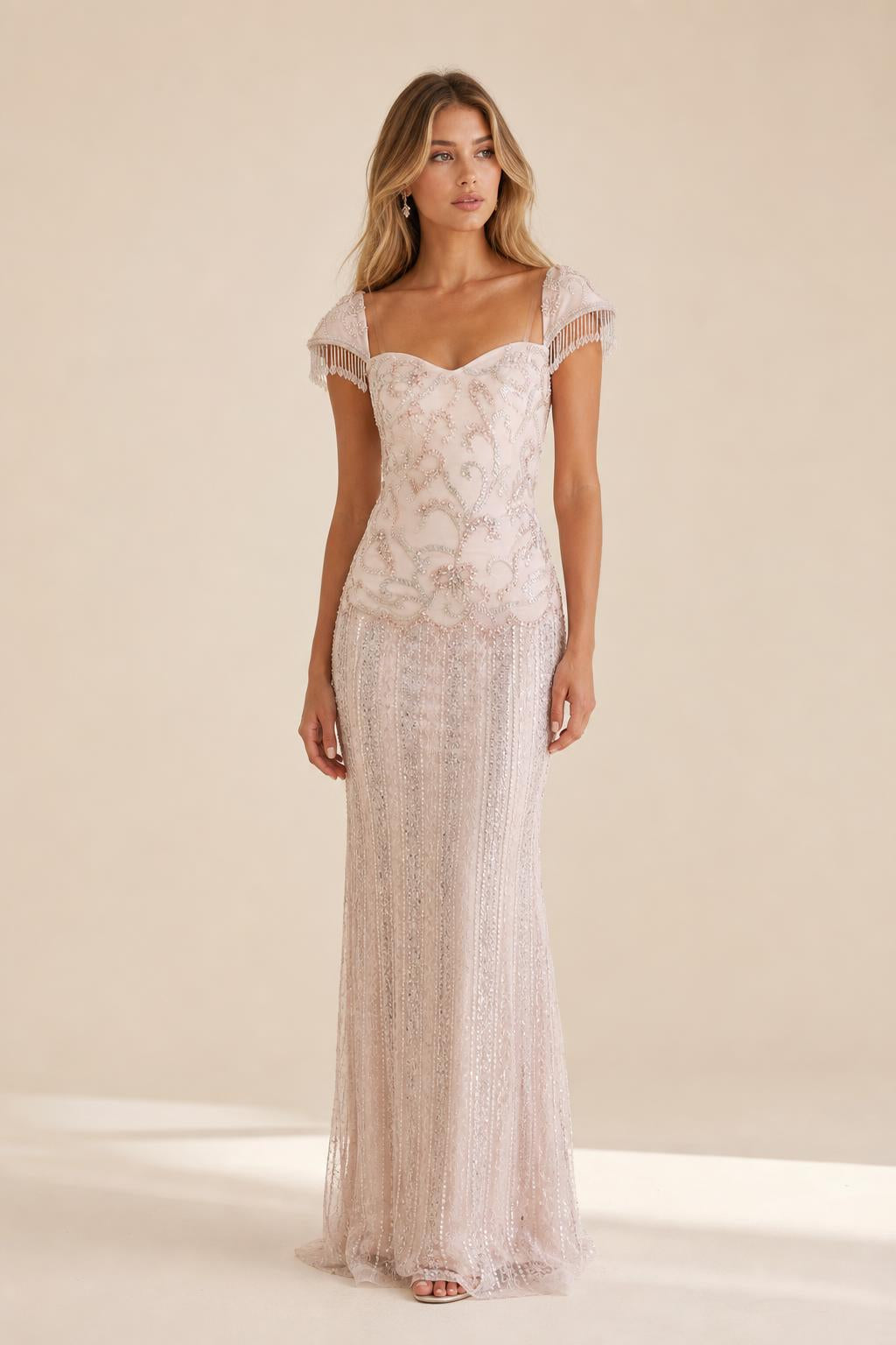 Front view of the blush beaded evening gown