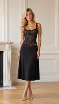 Front view of black lace bodice midi dress with square neckline and flowing skirt