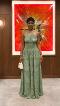 Woman wearing sage green halter neck textured maxi dress with fitted waist front view