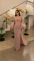 Blush beaded strapless column evening gown with oversized draped sleeves and train front view