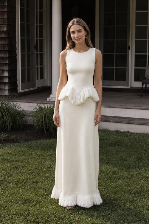 Front view of model wearing white fringed peplum maxi dress outdoors