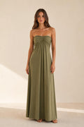 Woman wearing olive green strapless ruched maxi dress front view