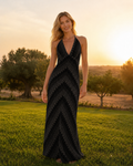 Front view of black chevron halter maxi dress with deep V neckline