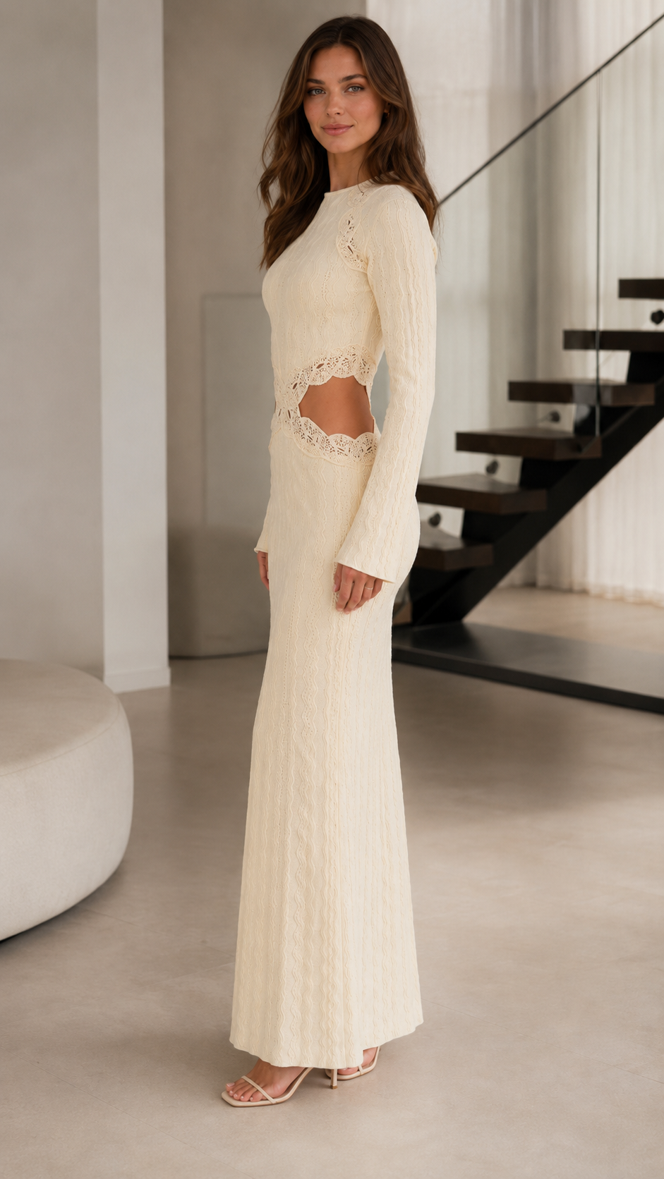 Side view of cream long sleeve textured maxi dress with waist cutout detail