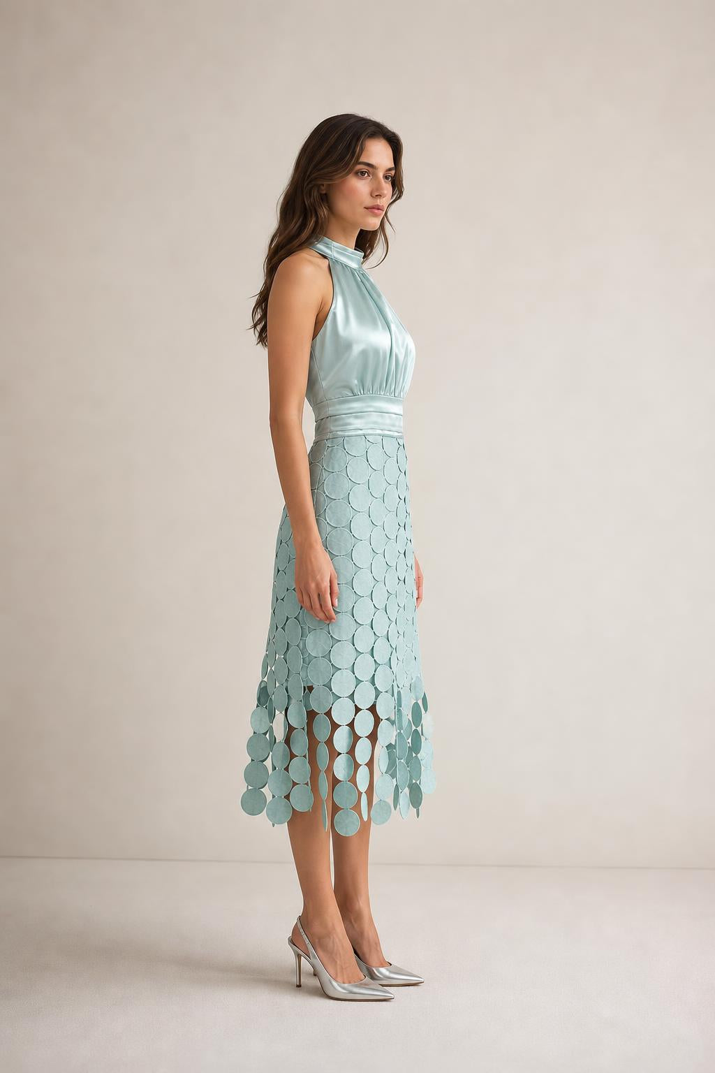 Side profile view of sage green satin halter midi dress