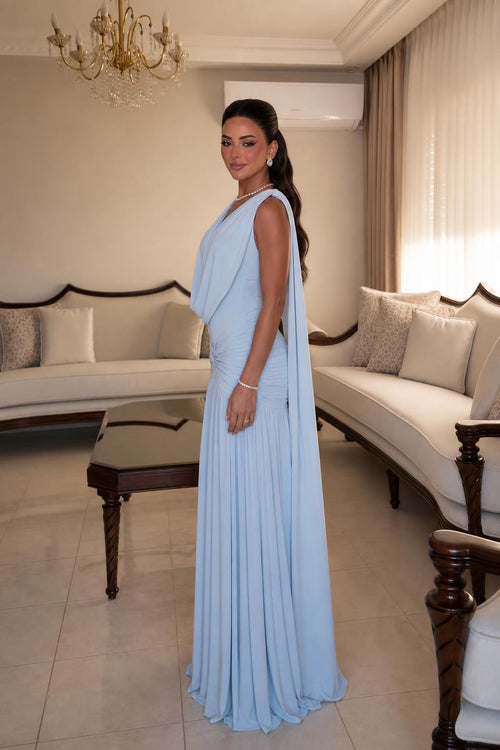 Side profile view of Light Blue draped cape dress