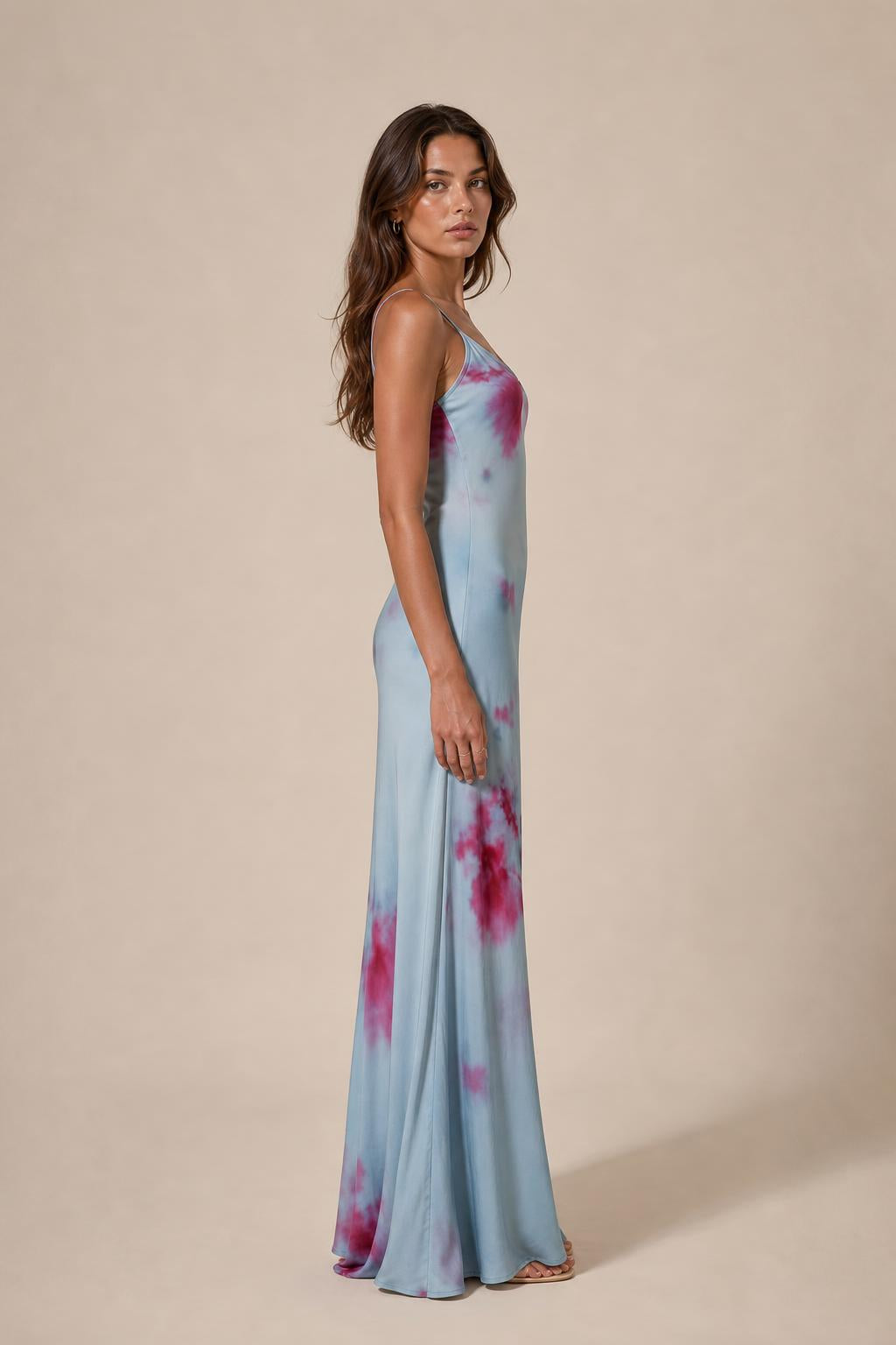 Model wearing light blue tie-dye cami slip maxi dress, side profile