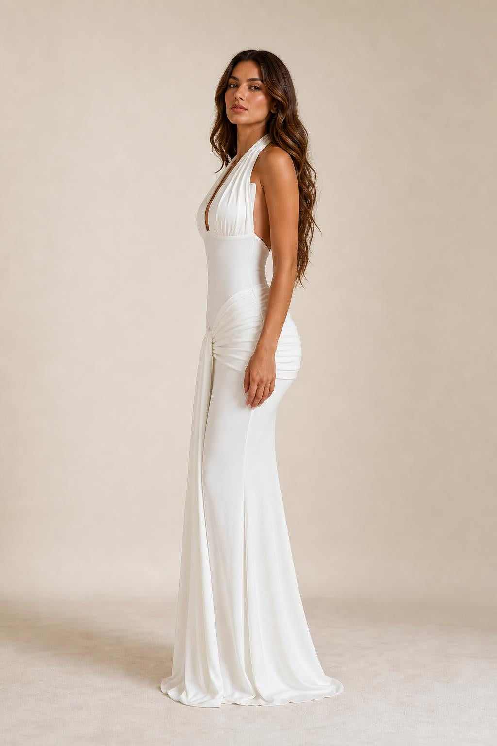 Side profile of woman in white halter evening gown