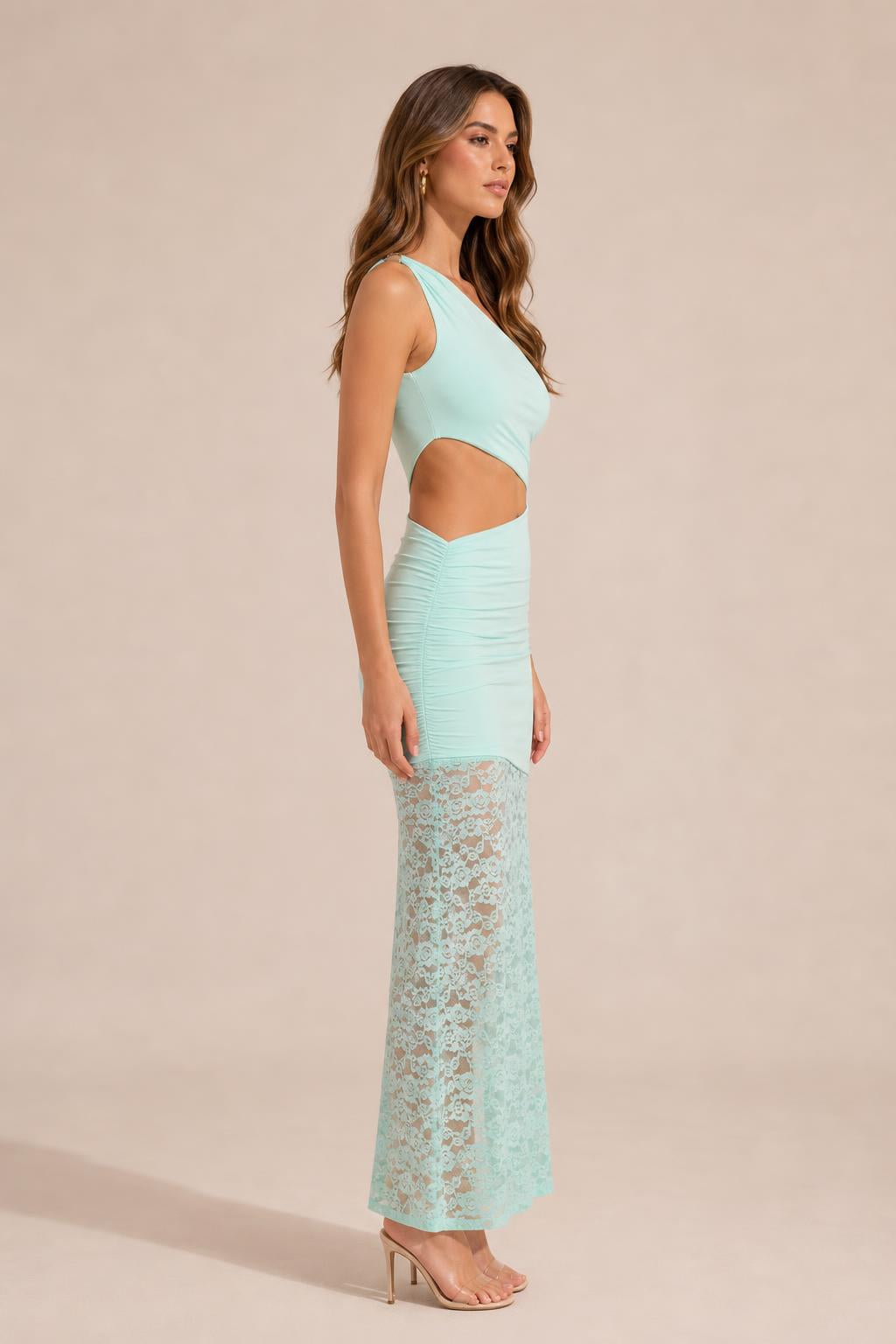 Side profile view of mint one-shoulder cutout dress