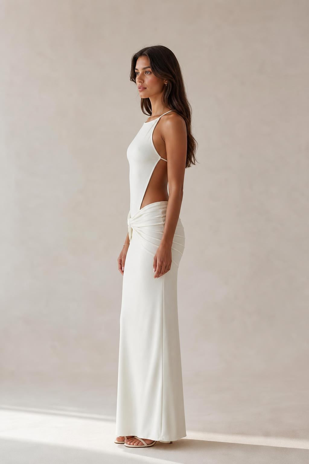Side profile view of white cut-out maxi dress