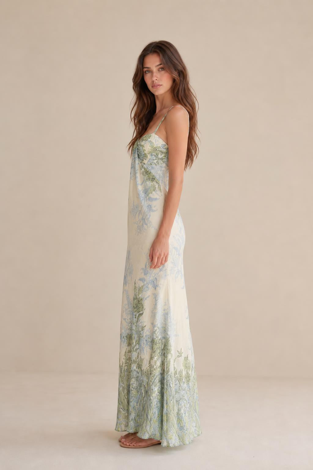 Side view of model wearing ivory floral maxi dress