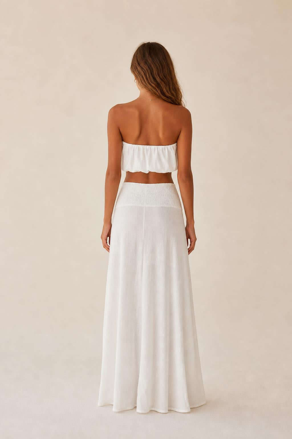 Back view of the white two-piece set showing relaxed wide leg drape