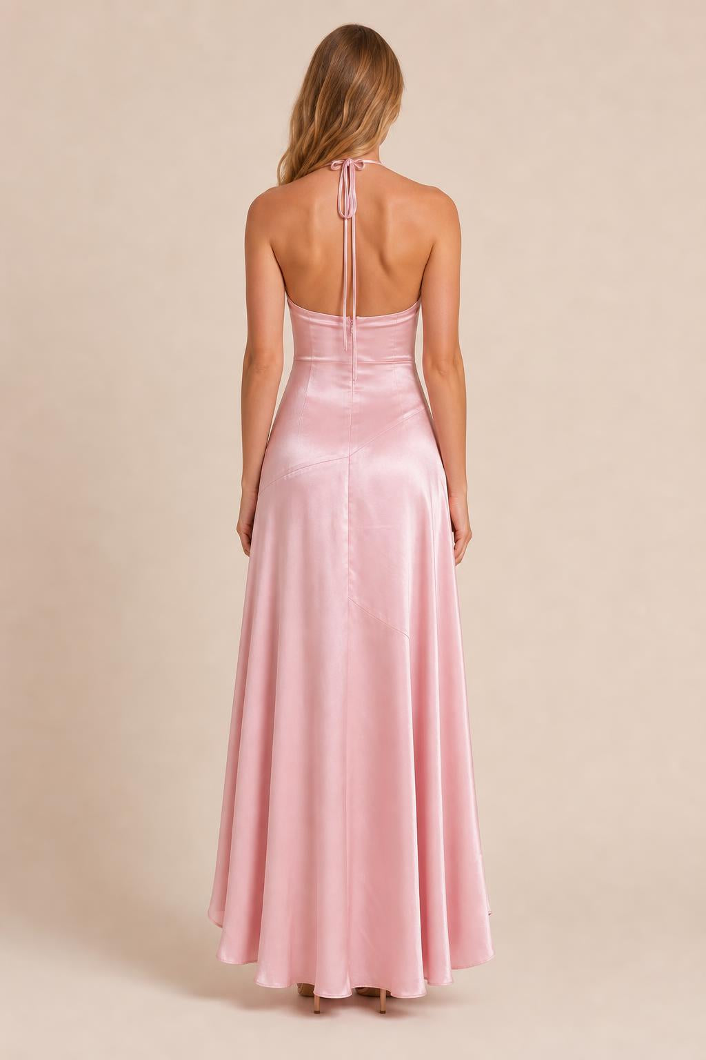 Back view of model wearing pink satin halter dress with tie details