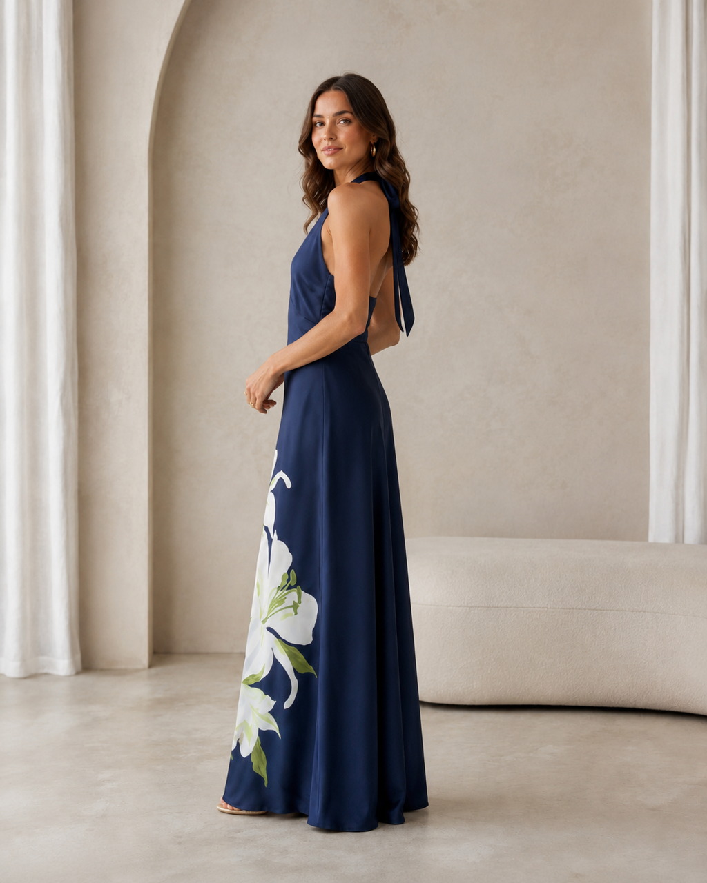 Side view of navy floral halter maxi dress with open back