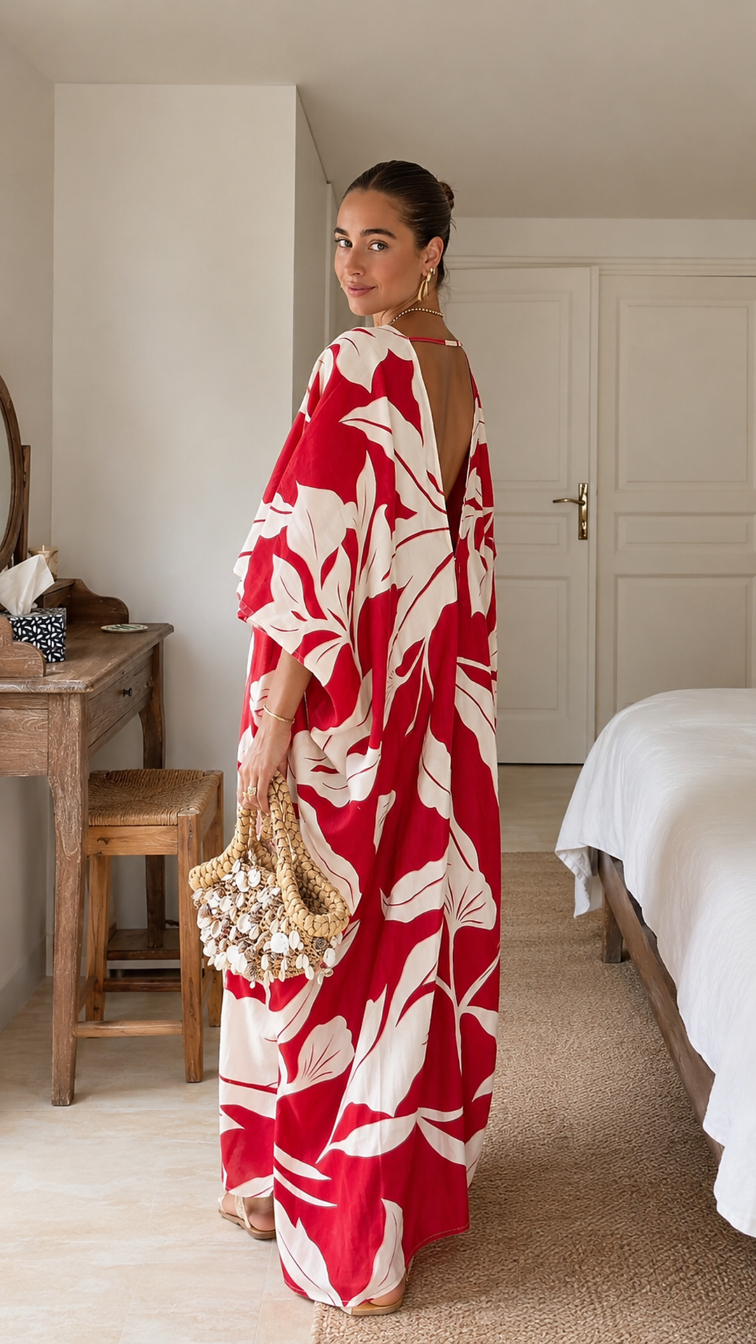 Back three-quarter view of red tropical print maxi caftan with low open back