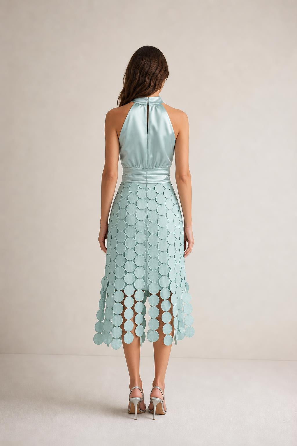 Back view of sage green satin halter midi dress with button closure