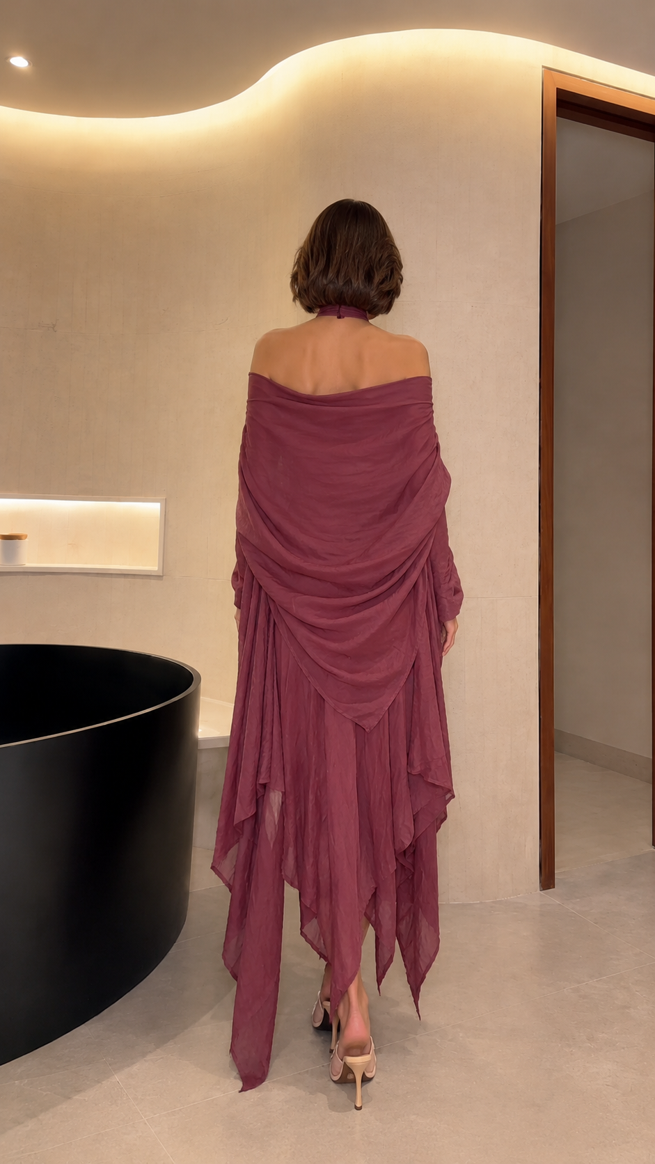 Back view of mauve off-shoulder maxi dress showing draped back and pointed handkerchief hem