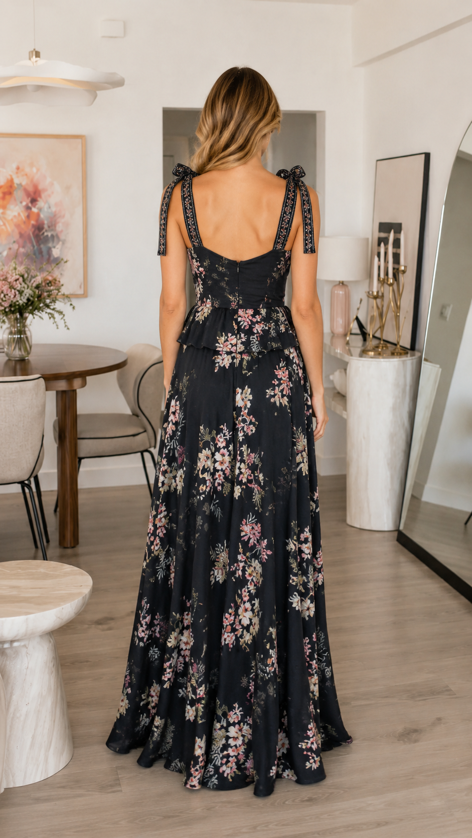 Back view of black floral maxi dress with tie shoulders and full-length drape