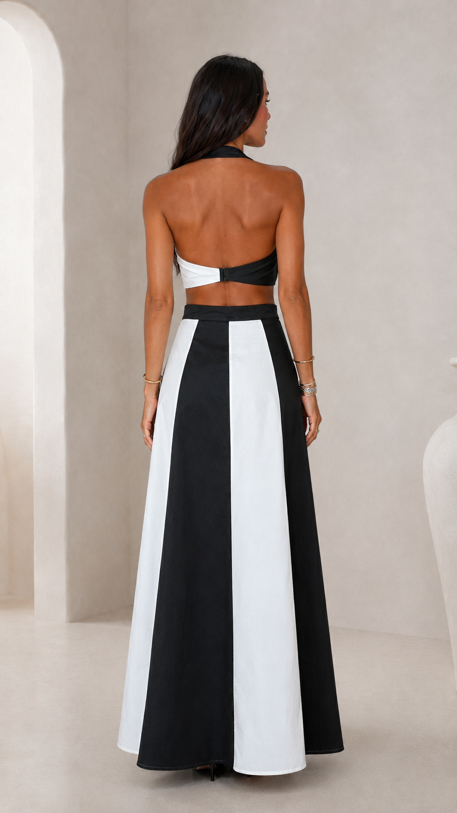 Back view of black and white halter top and color block maxi skirt set