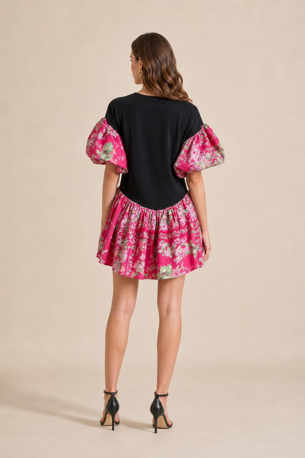 Back view of model showing back of black graphic mini dress