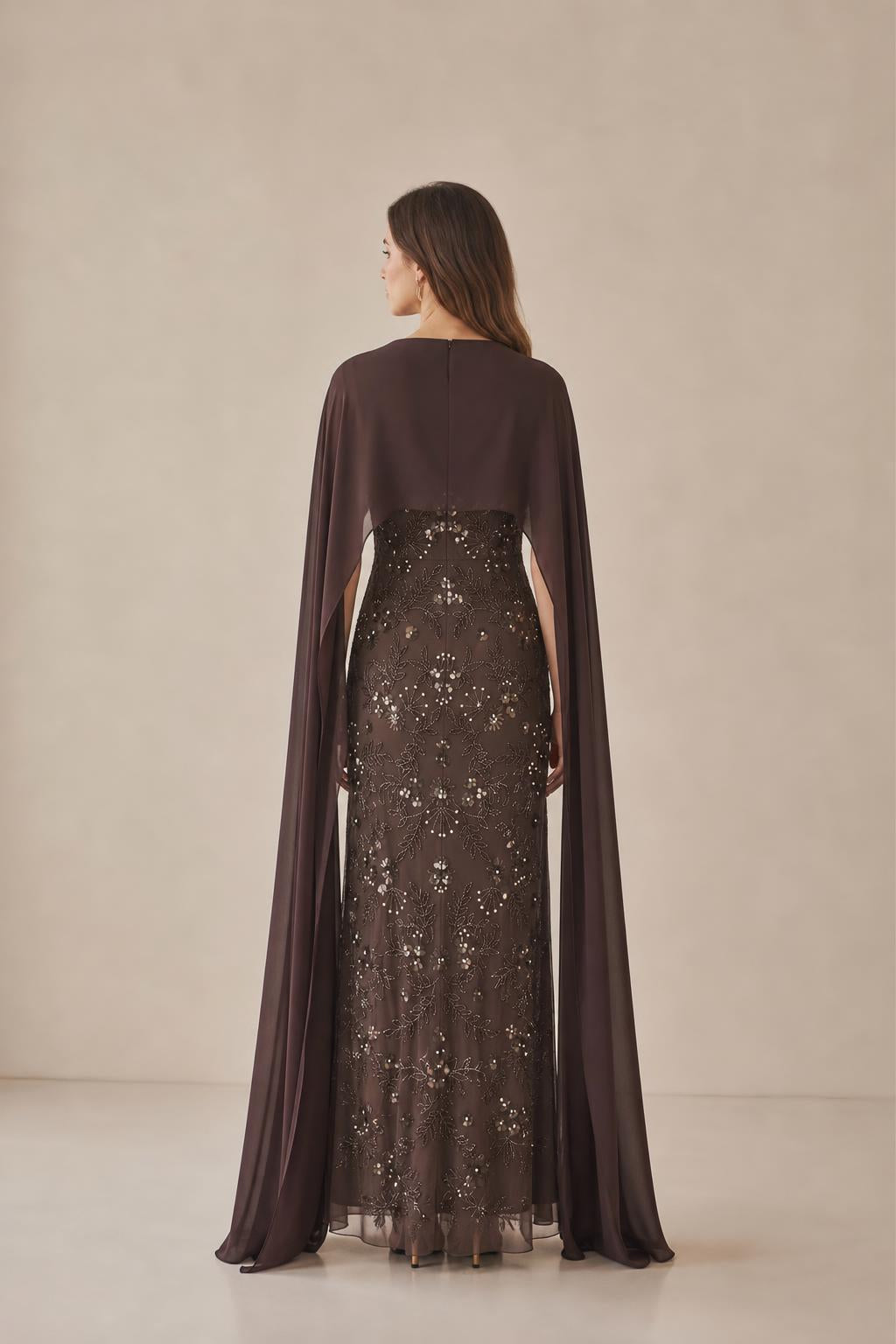 Back view of model showcasing flowing cape overlay