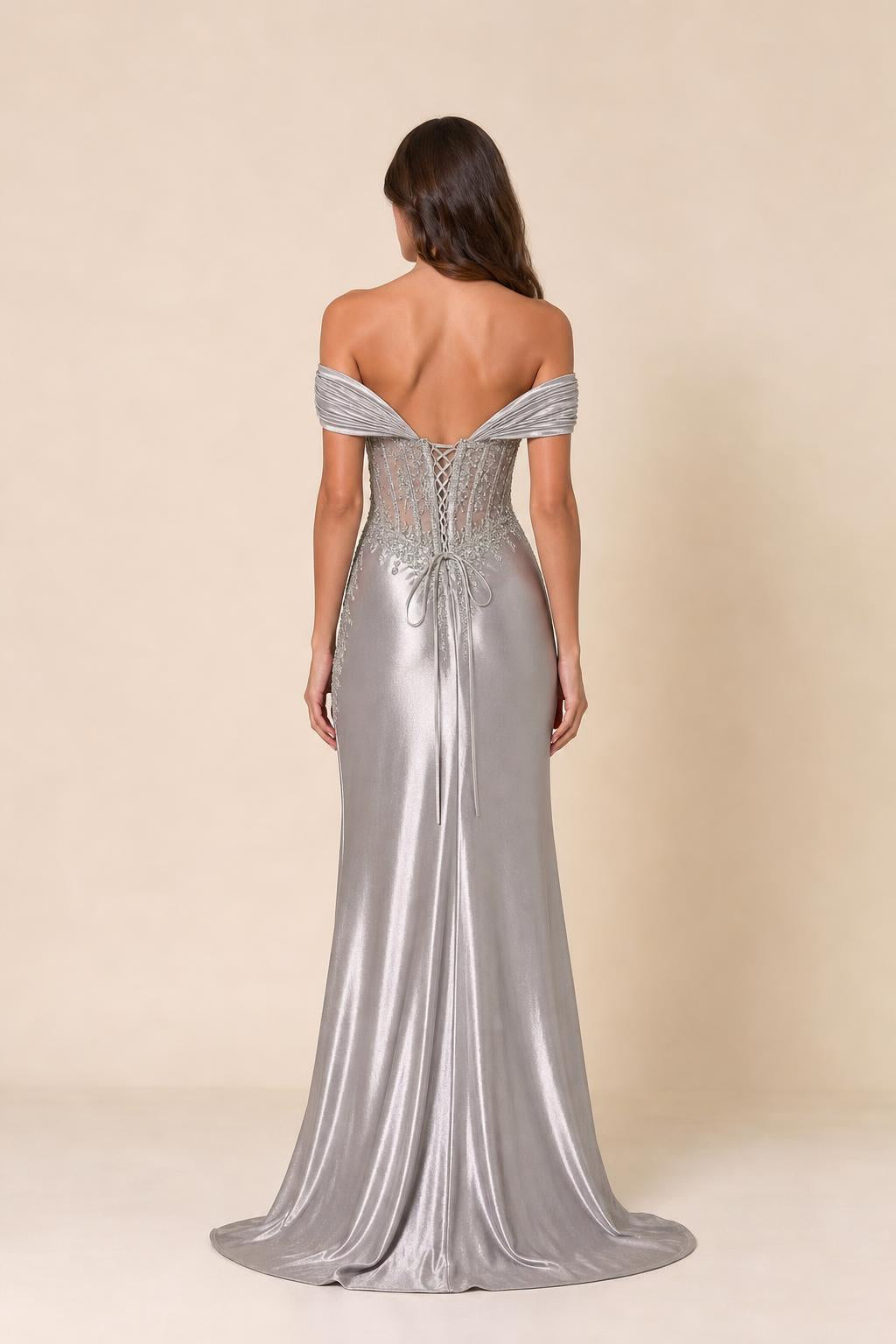 Back view of woman showcasing lace-up corset back of evening gown