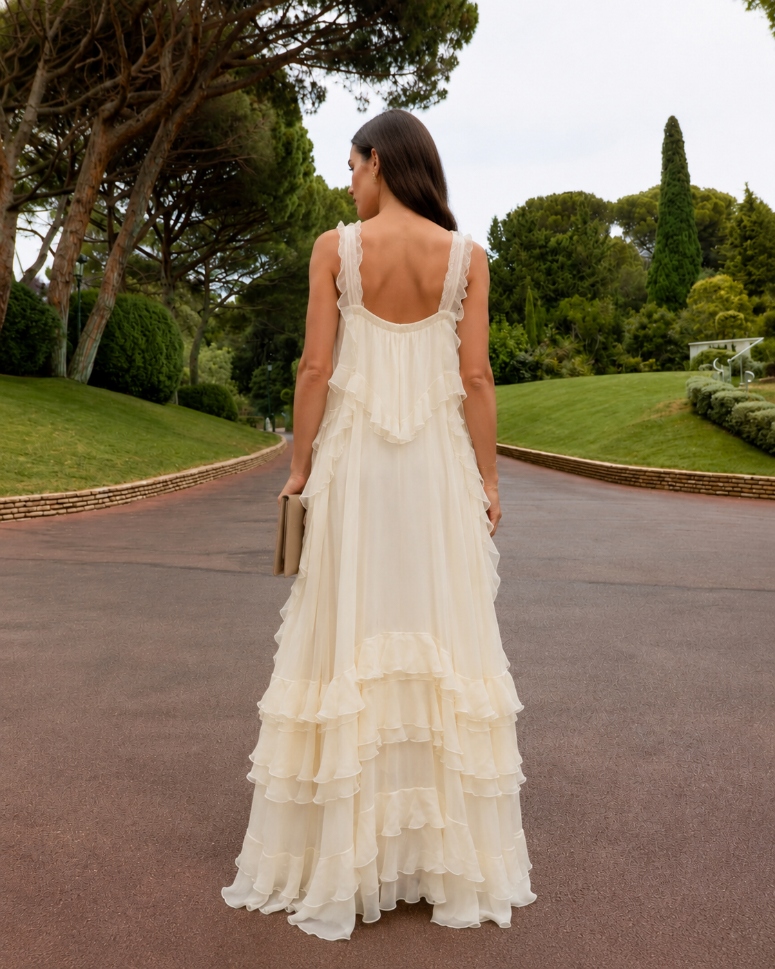 Back view of cream maxi dress with low back and tiered ruffle skirt