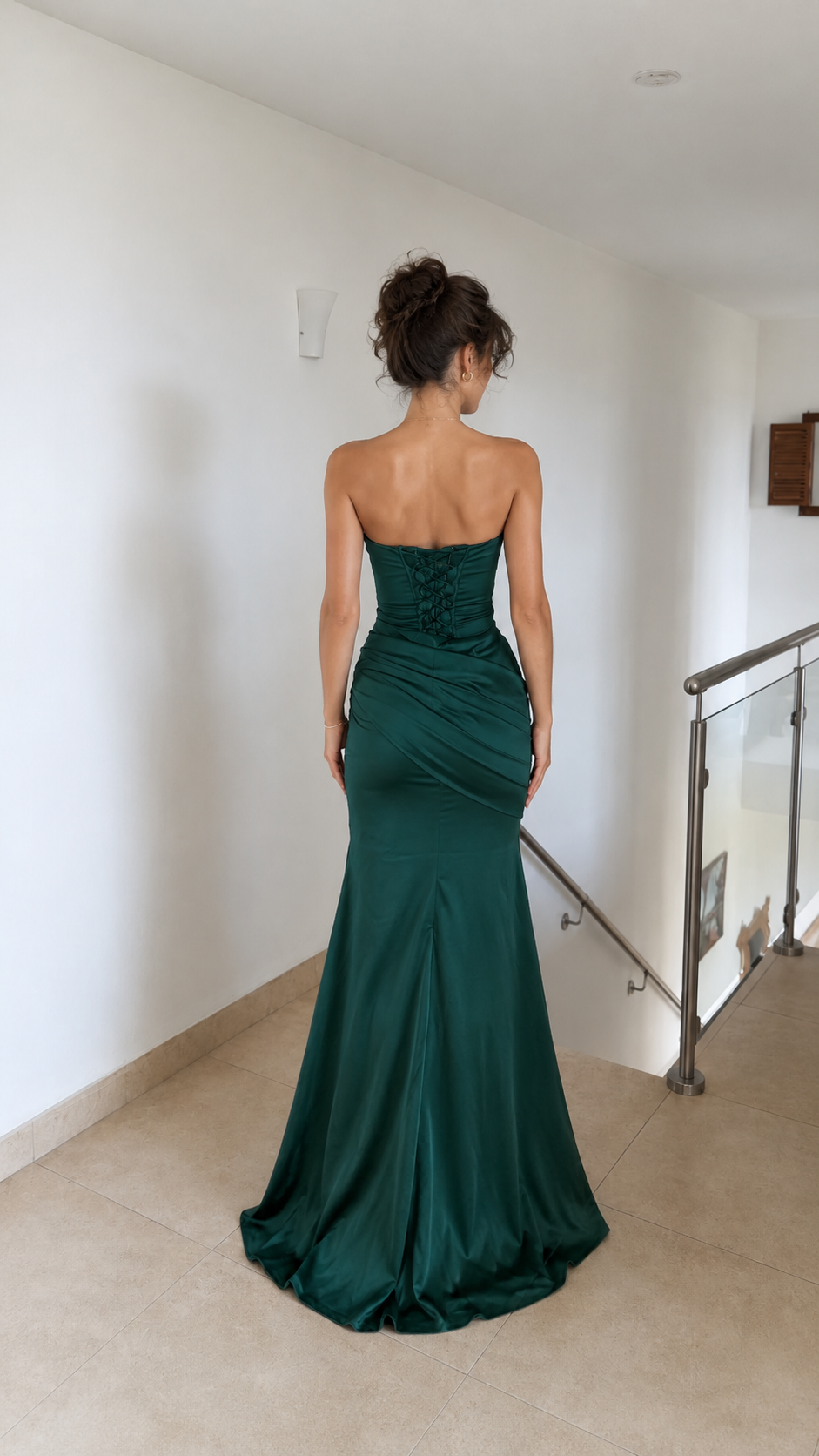 Back view of emerald strapless mermaid gown with lace-up back detail