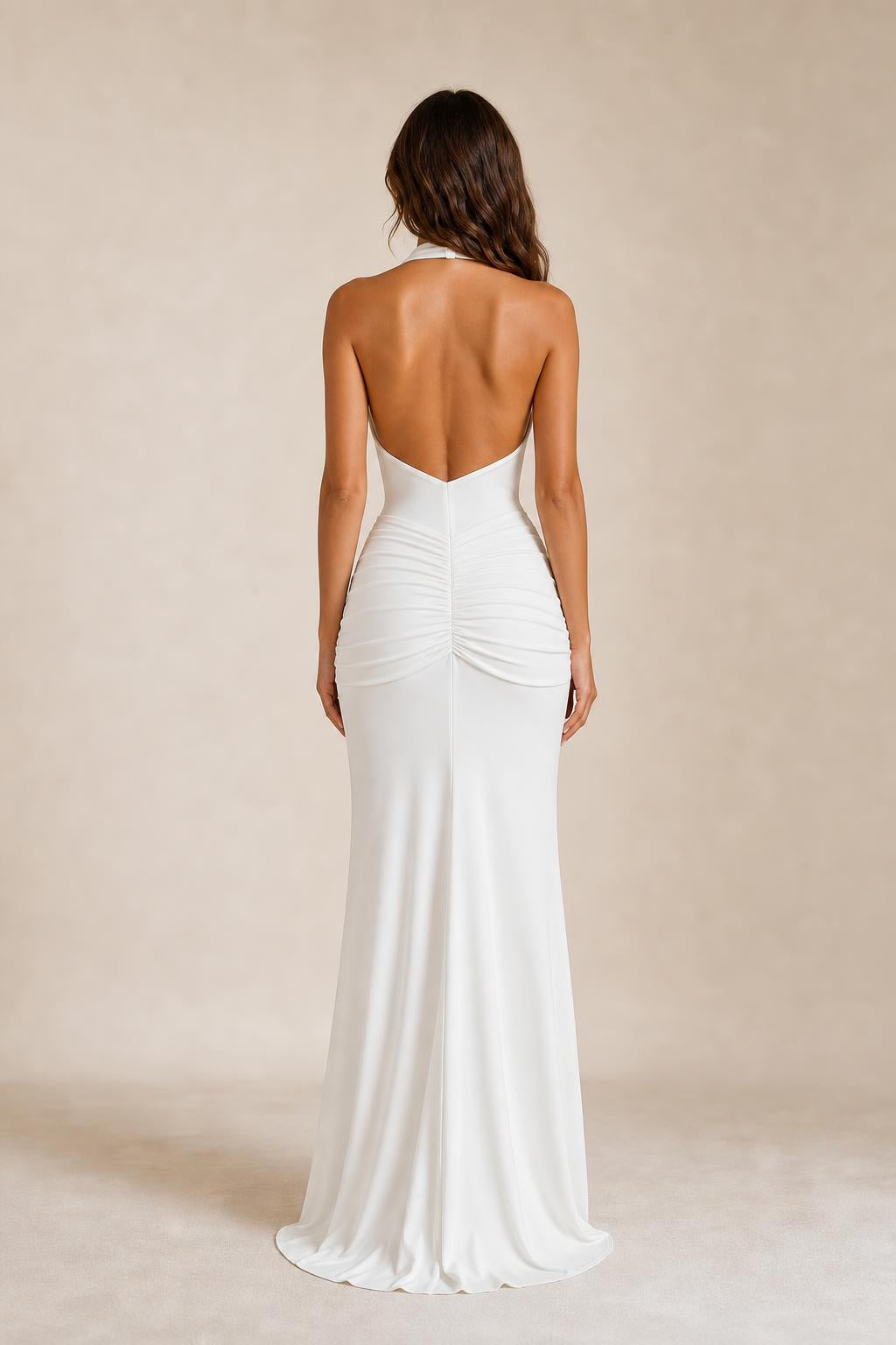 Back view of woman showing low back and hip ruching on white maxi dress