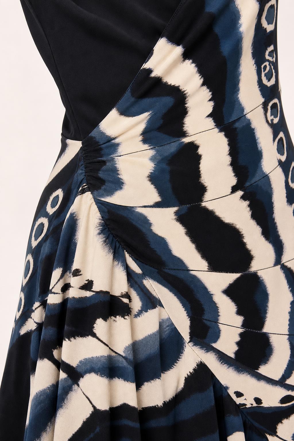 Close-up of side ruching and wrap detail on black maxi dress