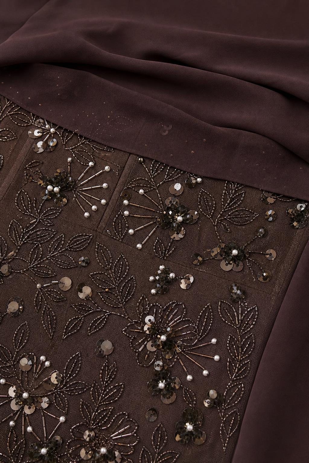 Close-up detail of sequin and bead embroidery on dress