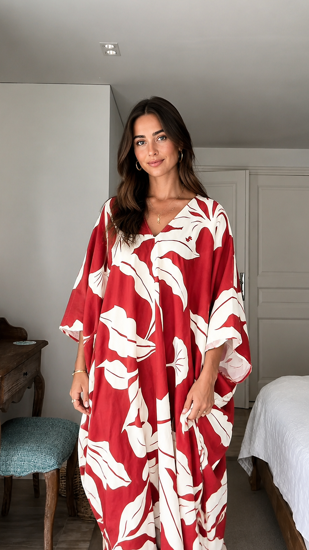 Close-up front detail of red and cream tropical print V-neck caftan dress
