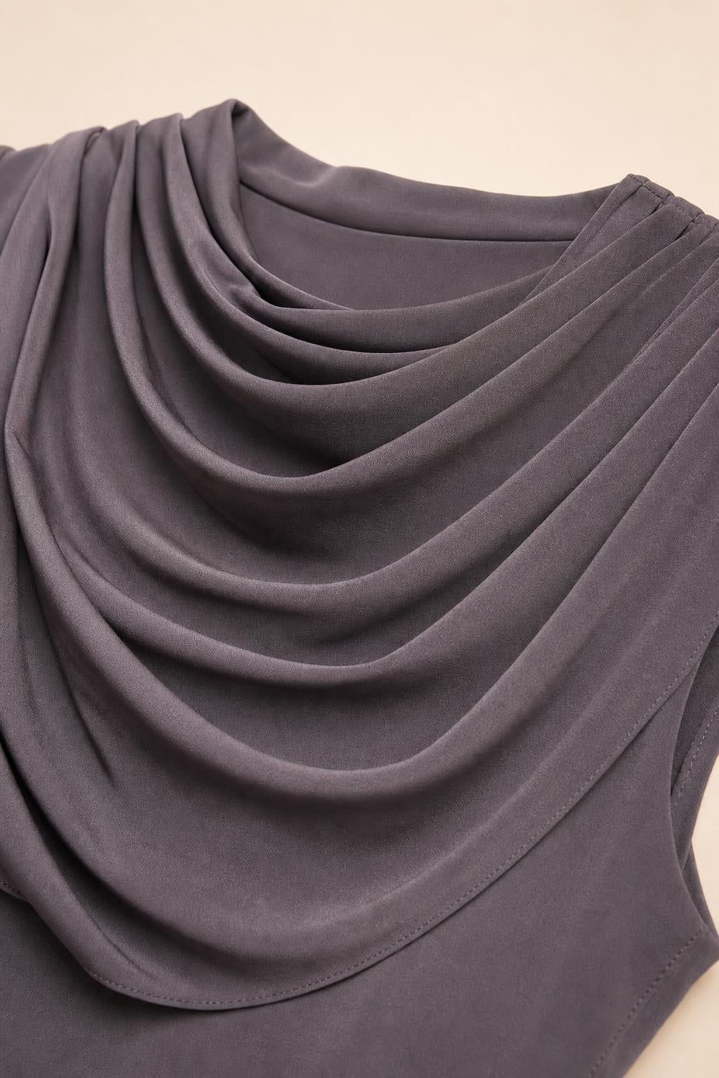 Close-up detail of cowl neckline and fabric texture