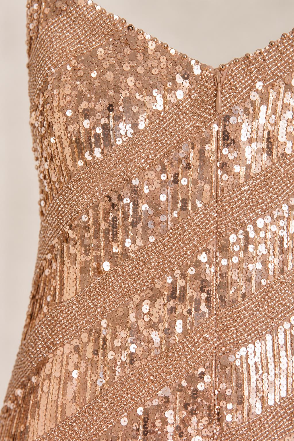 Close-up of sequin texture and V-neckline details