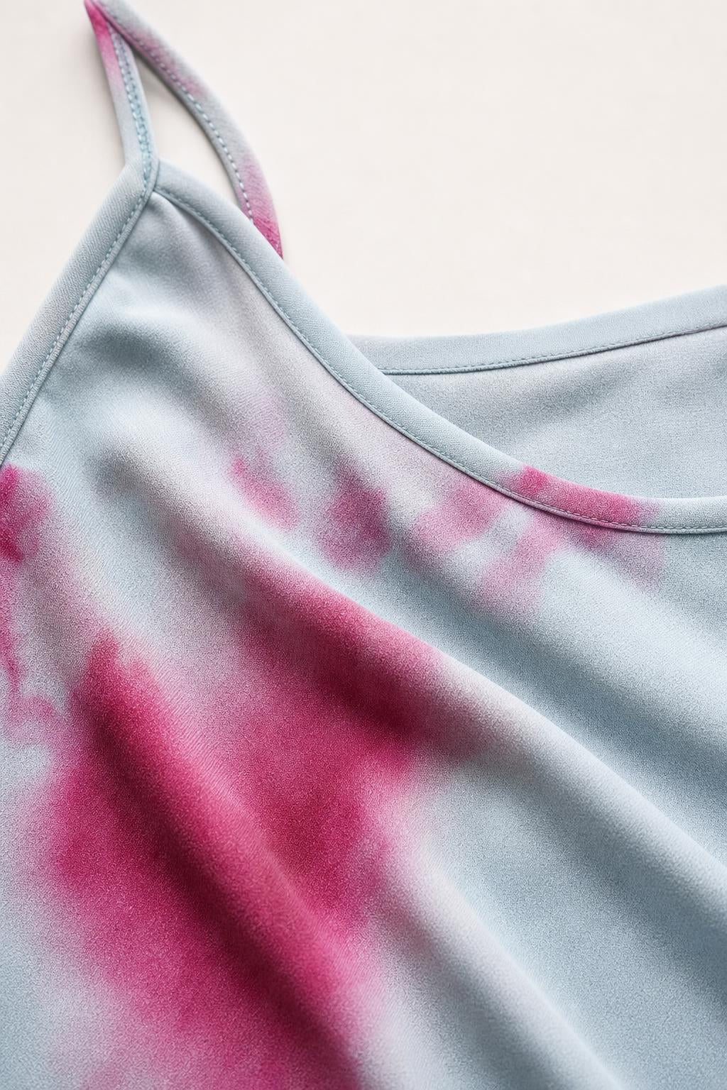 Close up of scoop neckline and fabric texture on light blue tie-dye dress