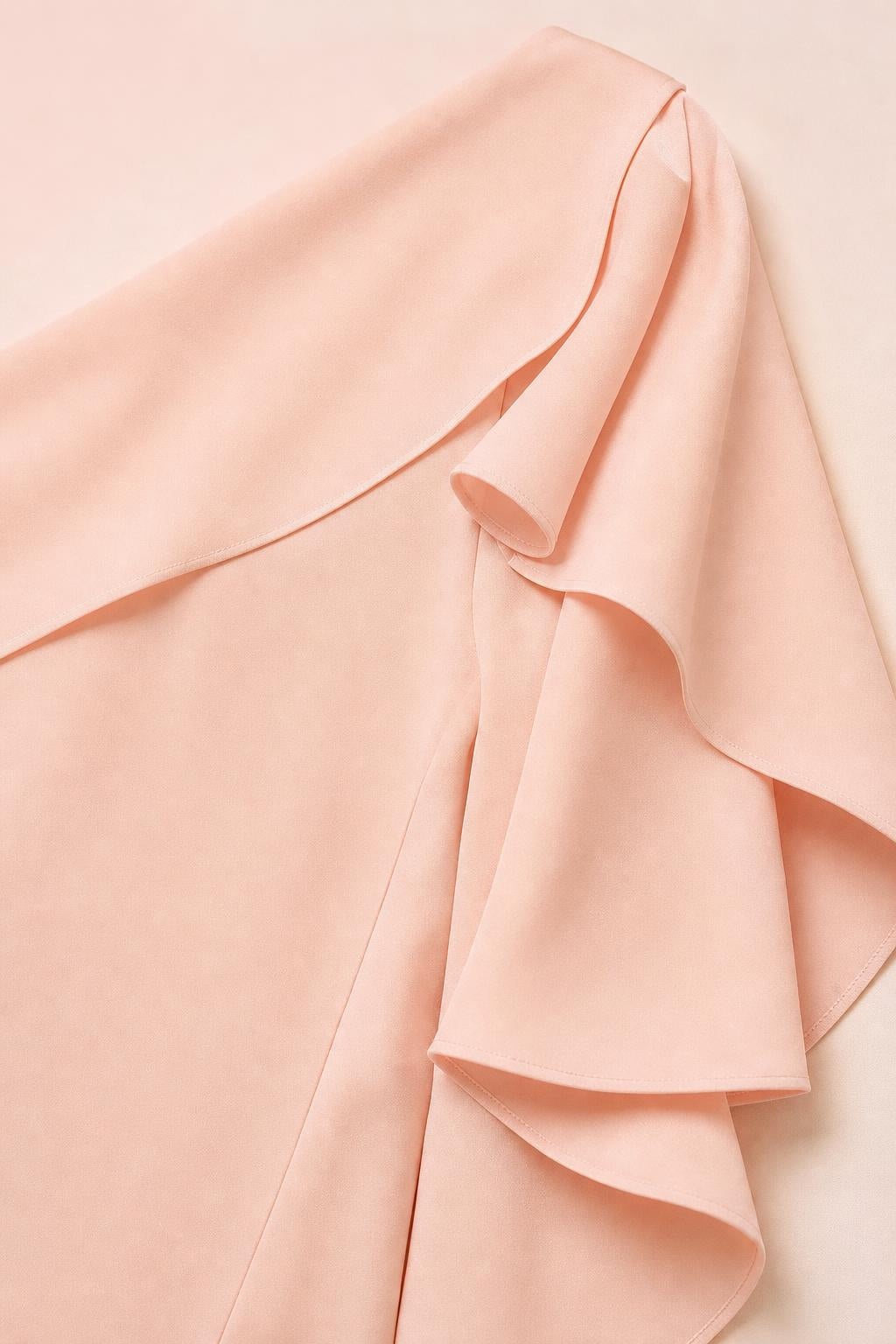 Close-up detail of the layered ruffle sleeve on the peach dress