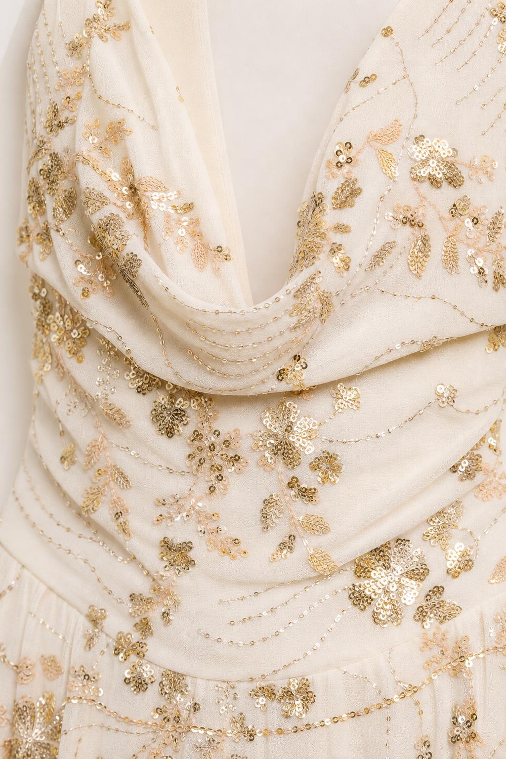 Close-up of cowl neckline and gold sequin floral embroidery