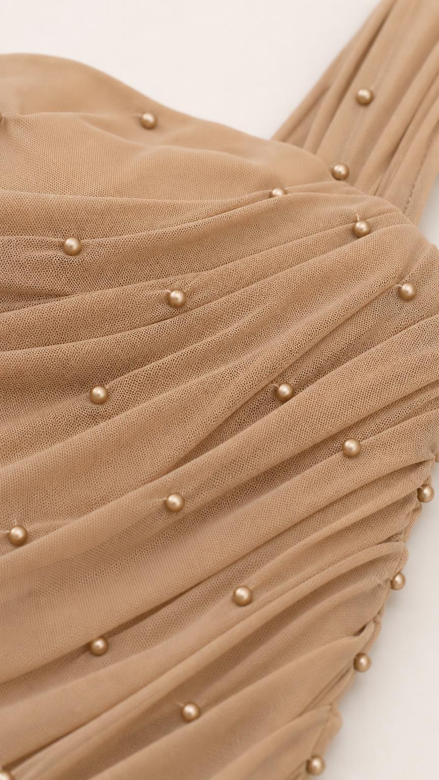 Close-up of pearl embellishments and ruched mesh fabric