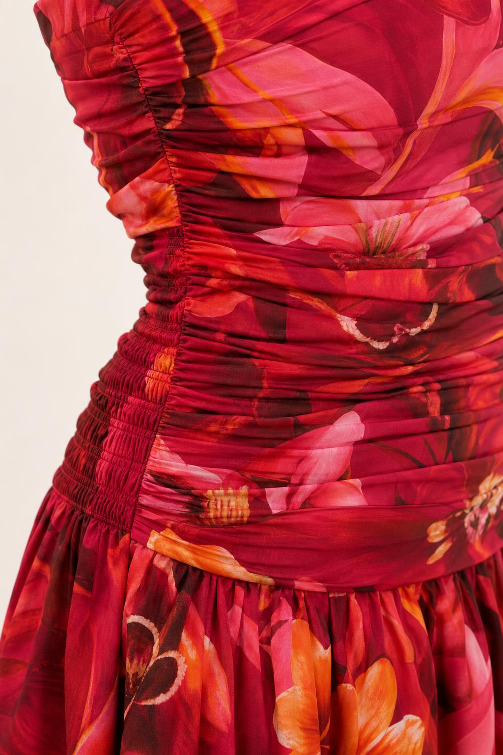 Close up of ruching detail on red floral top and skirt