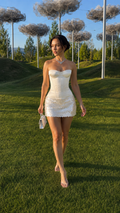 Front view of ivory strapless corset sequin mini dress outdoors