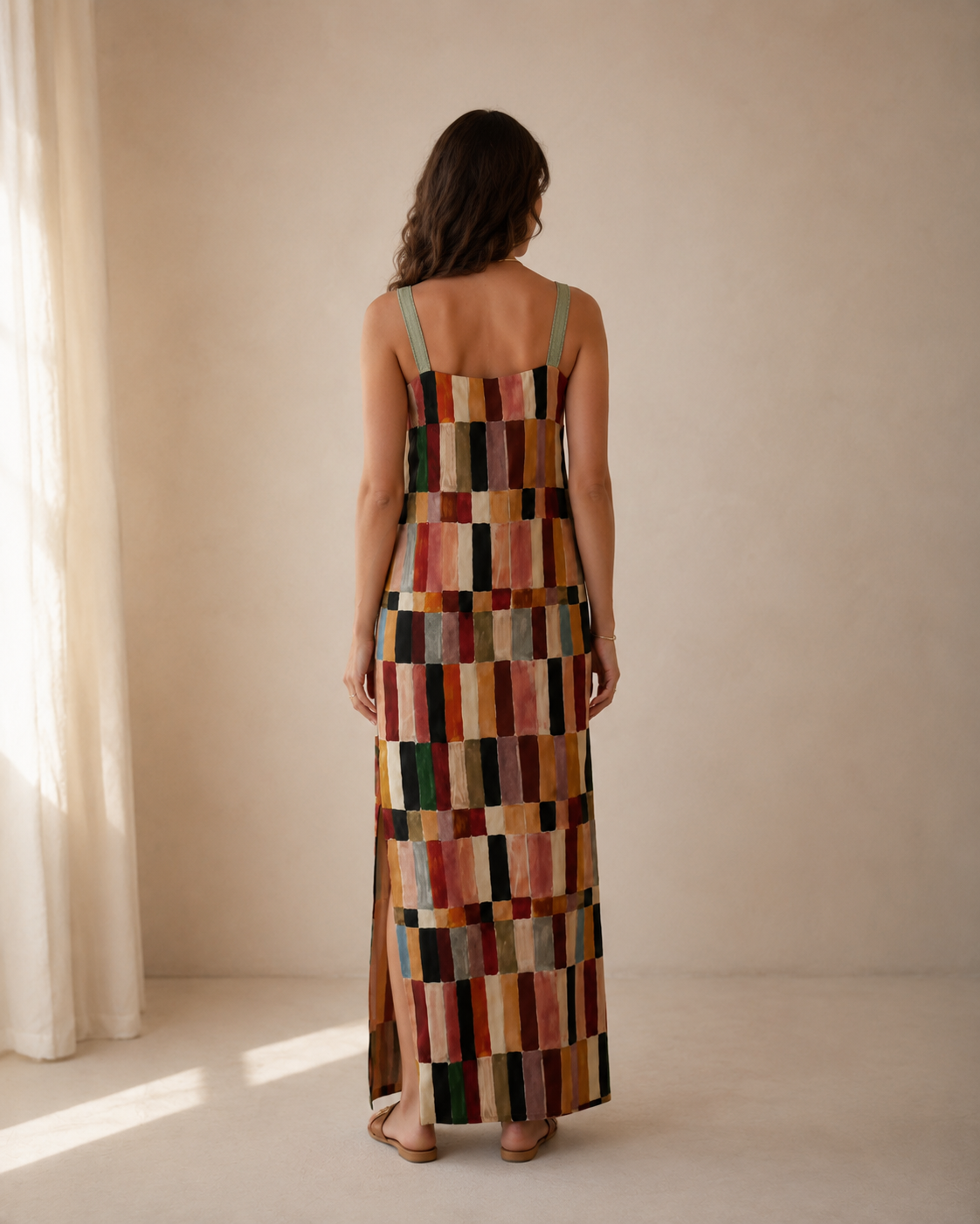 Back view of multicolor patchwork-style sleeveless maxi dress with slim straps