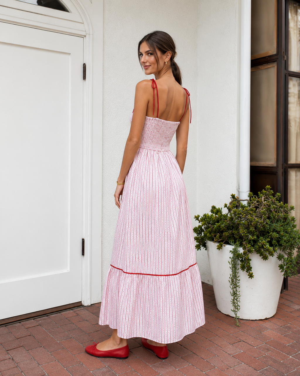 Blush pink striped maxi dress back view showing smocked back bodice and tie straps