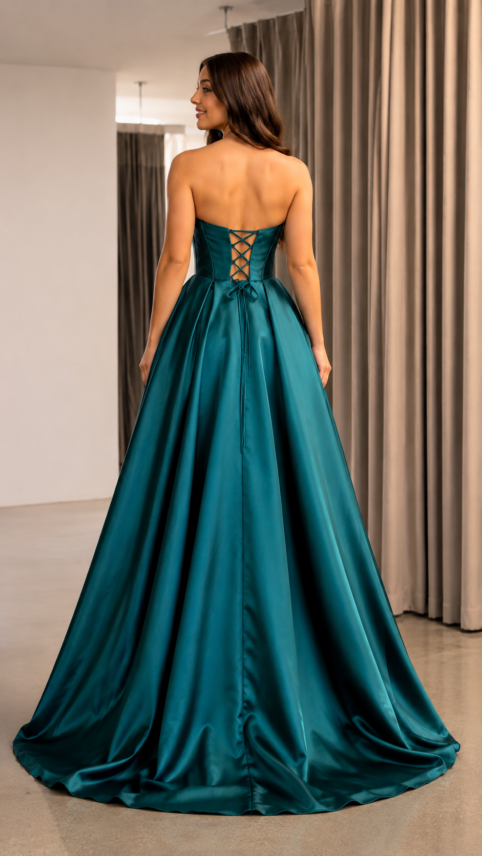 Back view of teal strapless formal gown with lace-up corset back and full skirt