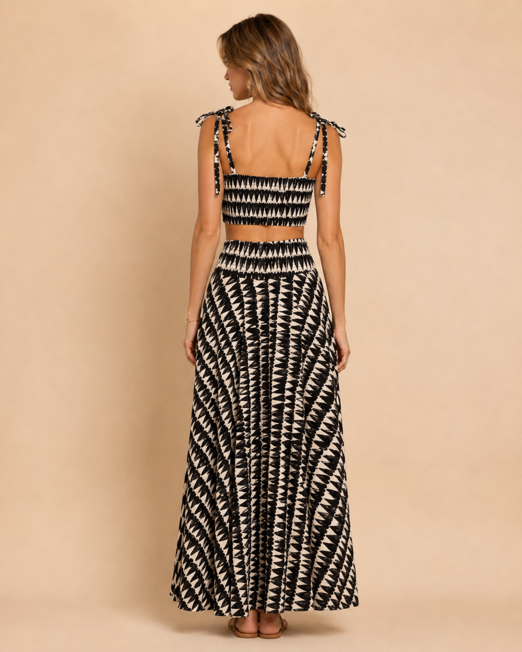 Back view of black and ivory printed smocked crop top and maxi skirt set