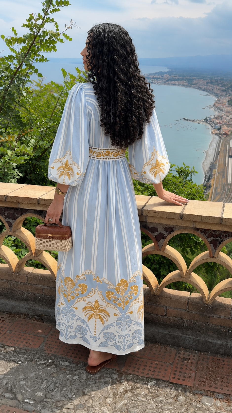 Back view of sky blue bohemian print maxi dress with flowing silhouette